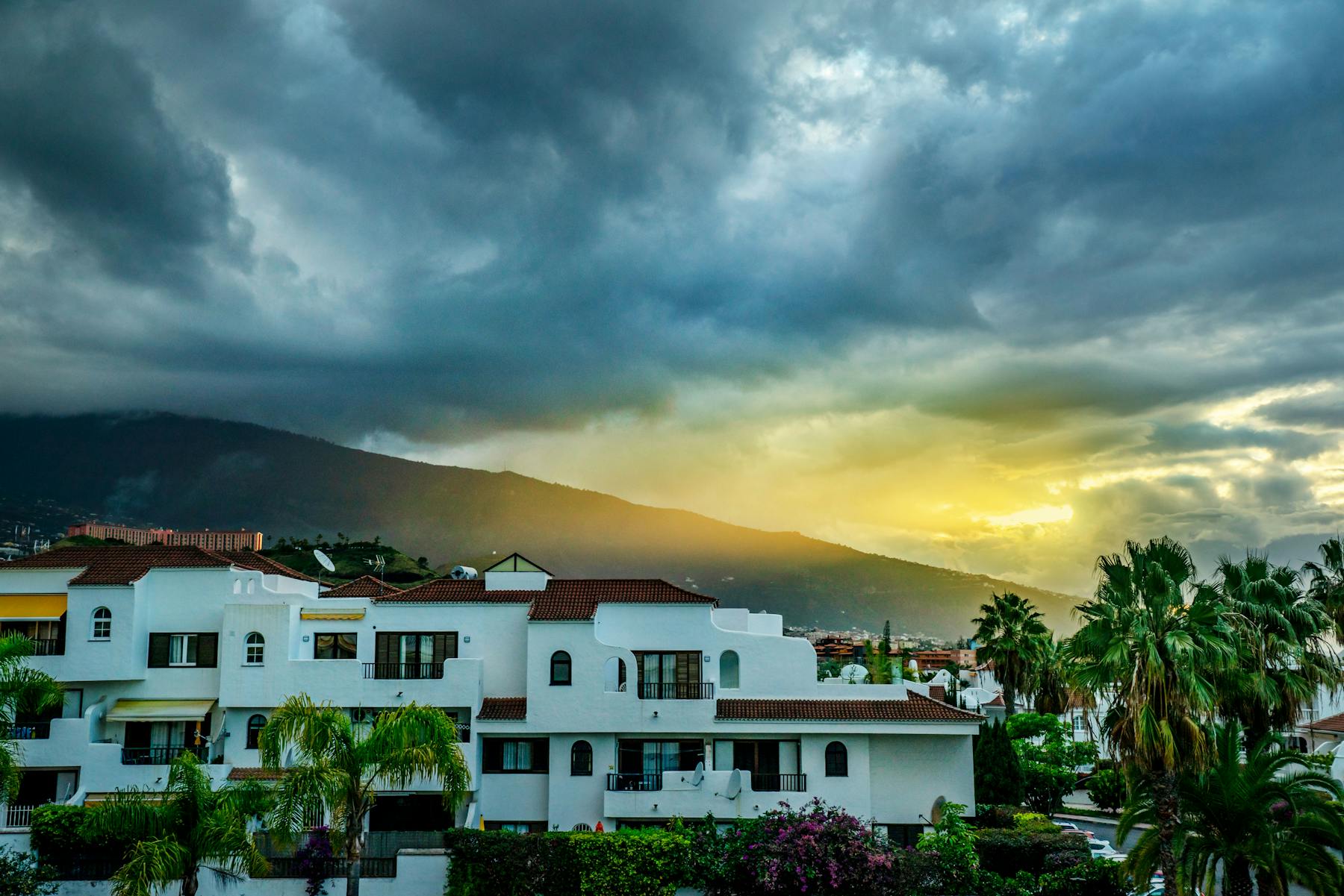 Coastal homes under a storm-charged sky